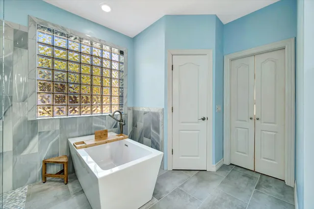 a bathroom with a tub and shower