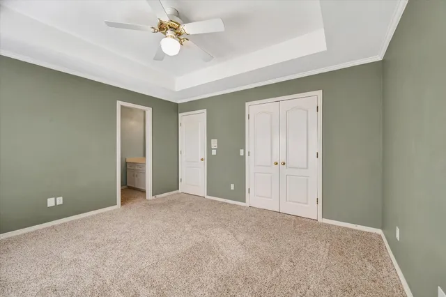 wooden floor in an empty room with a chandelier fan