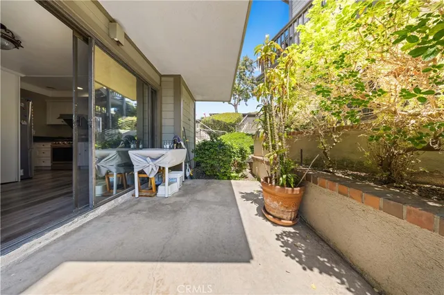 a view of a patio with table and chairs and potted plants
