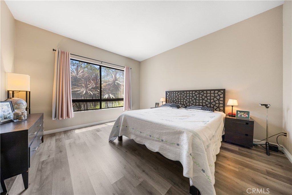 11 Palos, Unit 55 Irvine, CA 92612 - Photo 16 of 25 a bedroom with a bed and a large window