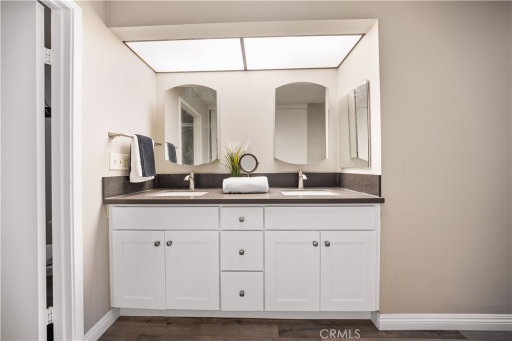 11 Palos, Unit 55 Irvine, CA 92612 - Photo 20 of 25 a bathroom with mirror and vanity