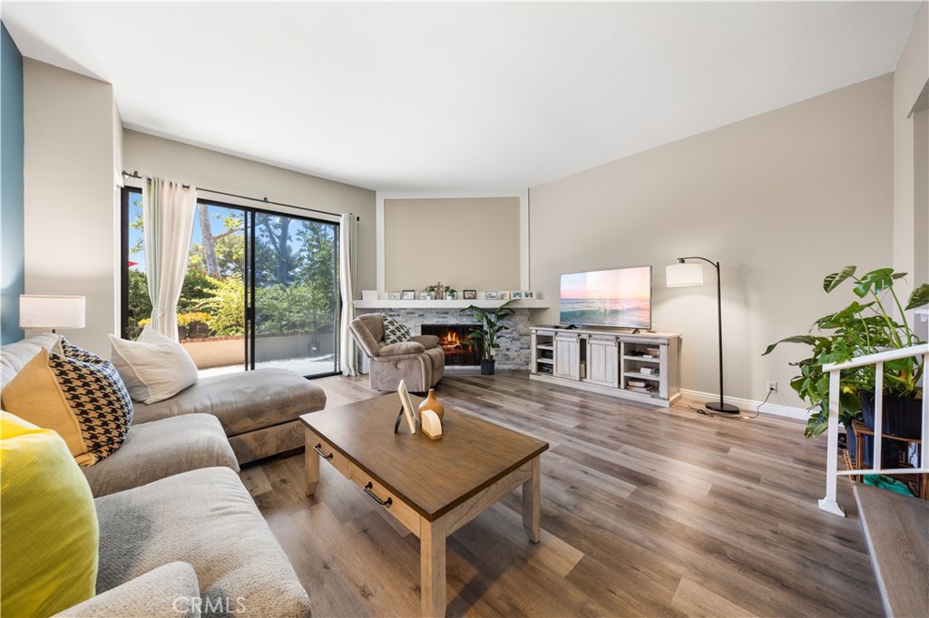 11 Palos, Unit 55 Irvine, CA 92612 - Photo 25 of 25 a living room with furniture a large window and wooden floor