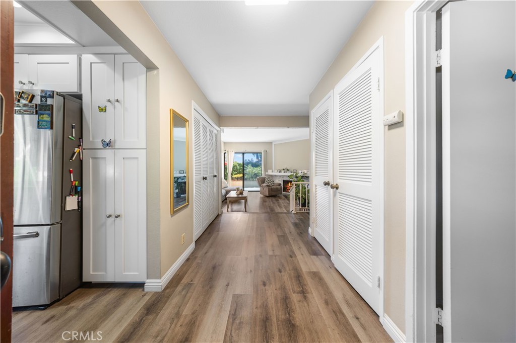 11 Palos, Unit 55 Irvine, CA 92612 - Photo 4 of 25 a view of a hallway with wooden floor and furniture