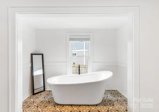 a white bath tub sitting in a bathroom