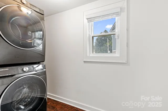 a utility room with mirror and window