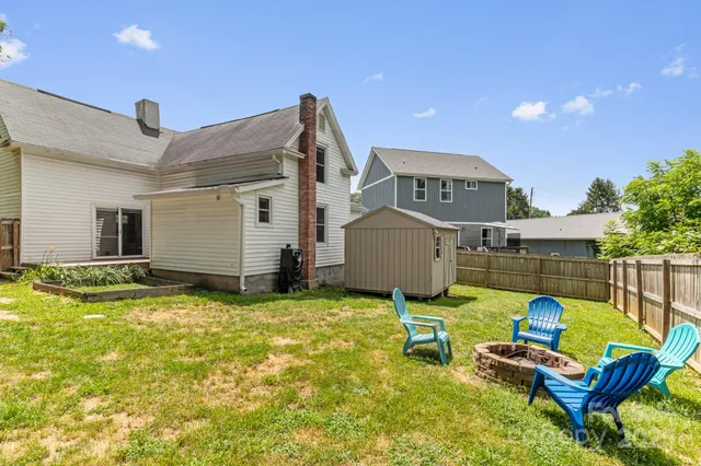 a view of a house with pool and chairs