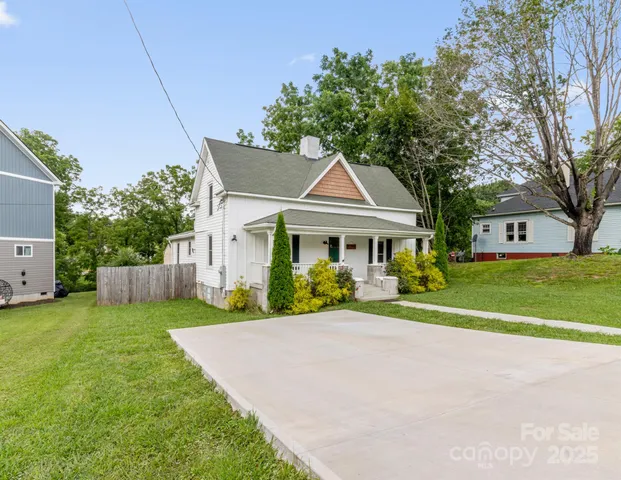 a front view of a house with a yard and porch