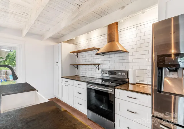 a kitchen with stainless steel appliances granite countertop a stove and a refrigerator