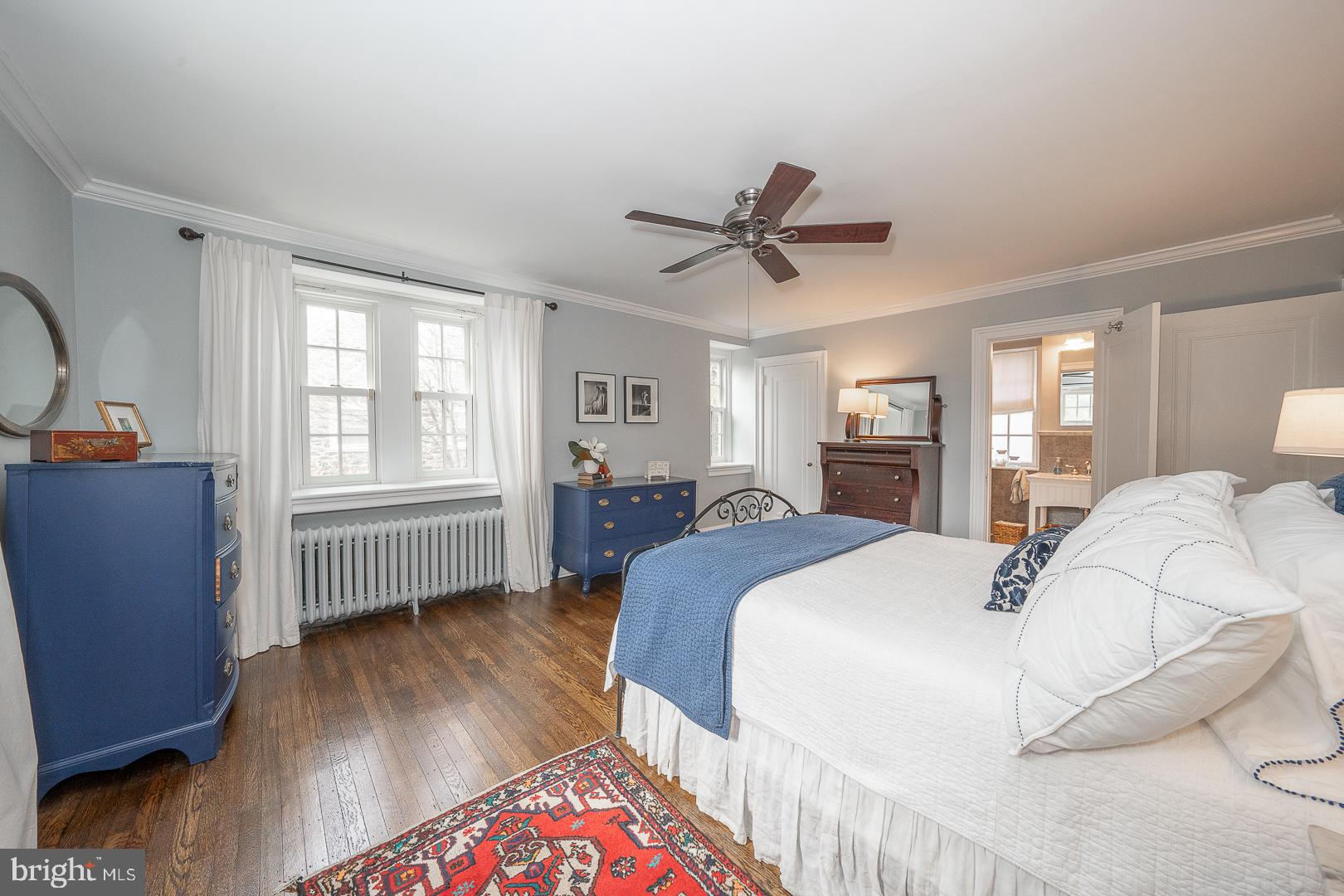 261 Kent Road Wynnewood, PA 19096 - Photo 50 of 98 a spacious bedroom with a bed a dresser and wooden floor