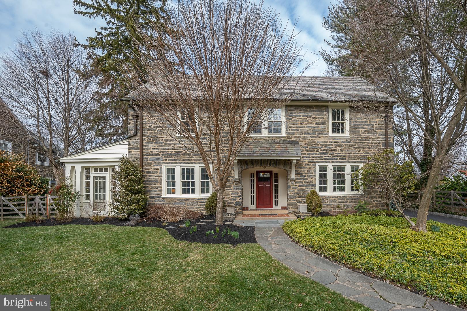 261 Kent Road Wynnewood, PA 19096 - Photo 5 of 98 a front view of a house with a yard and green space