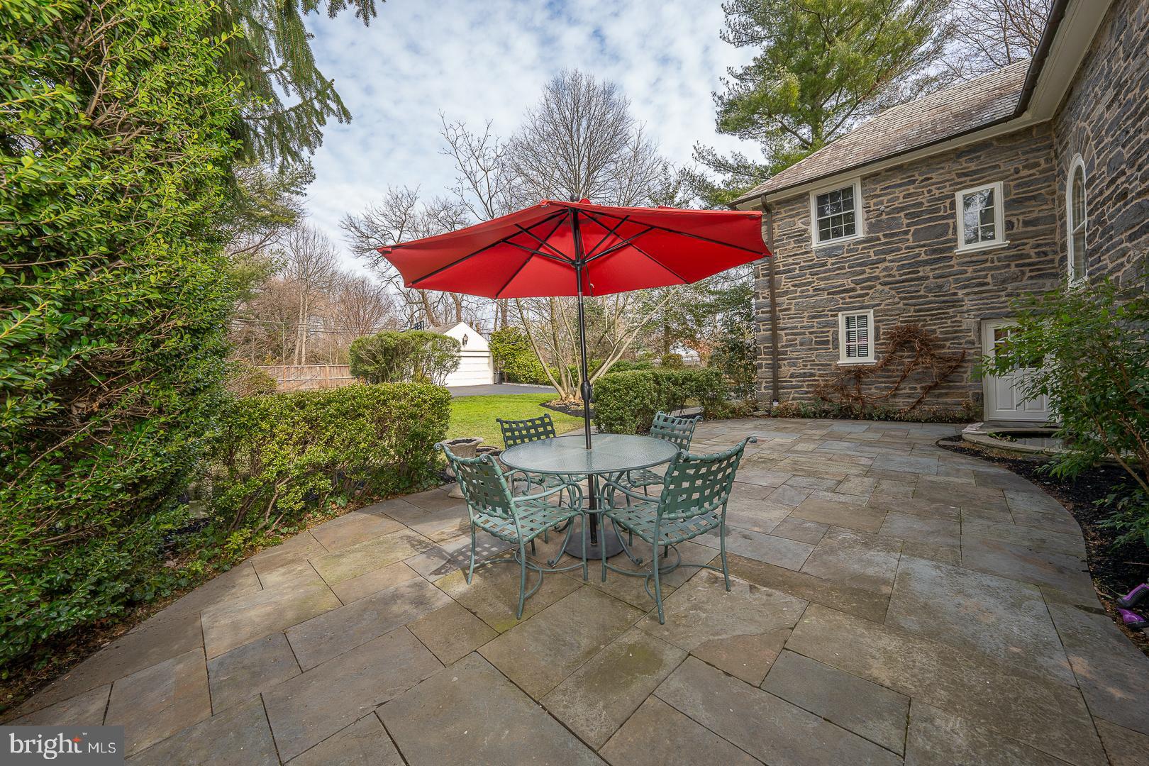 261 Kent Road Wynnewood, PA 19096 - Photo 80 of 98 a view of a house with backyard sitting area and blue umbrella