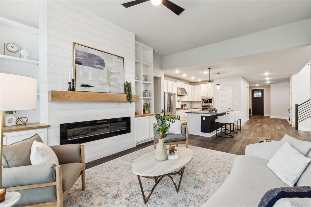 a living room with furniture kitchen view and a fireplace