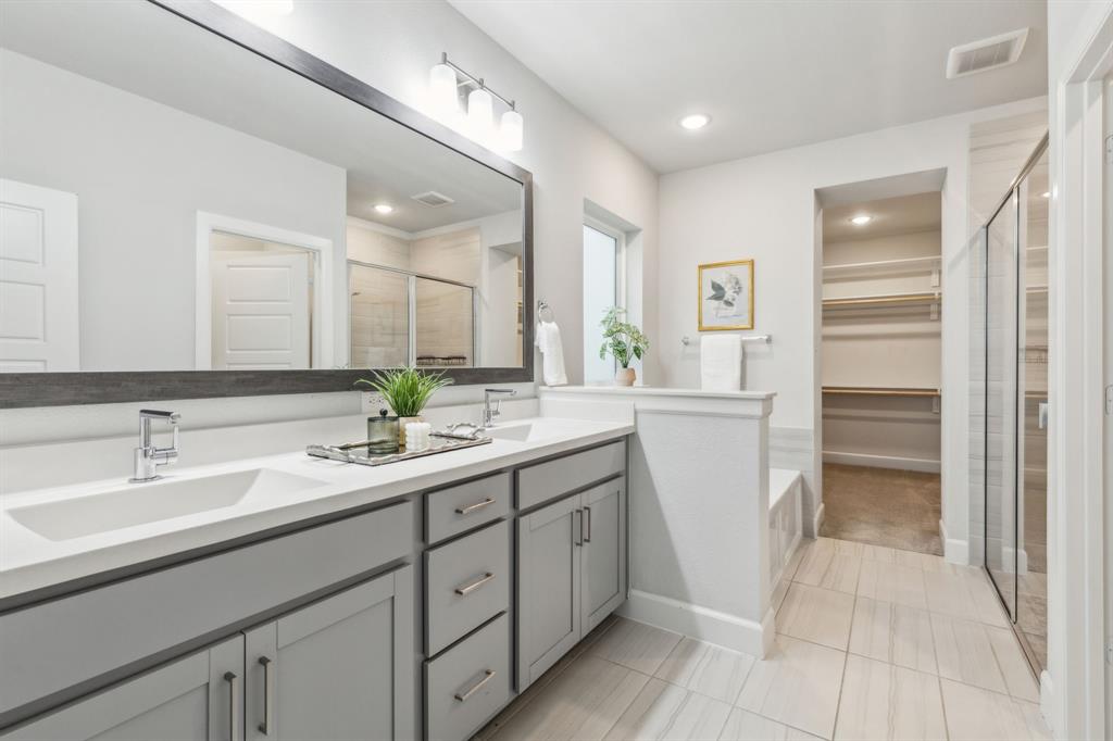 2417 Robin Way Northlake, TX 76247 - Photo 13 of 27 a bathroom with a sink a toilet and a mirror