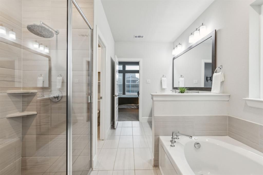 2417 Robin Way Northlake, TX 76247 - Photo 14 of 27 a bathroom with a bathtub and a shower