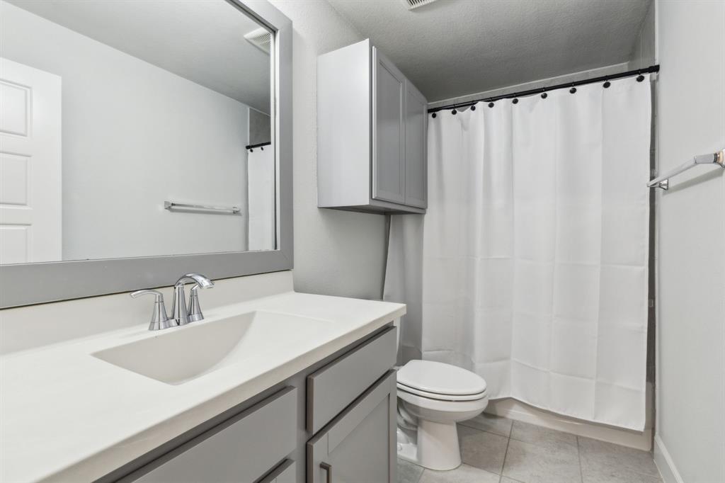 2417 Robin Way Northlake, TX 76247 - Photo 23 of 27 a bathroom with a sink a toilet and shower