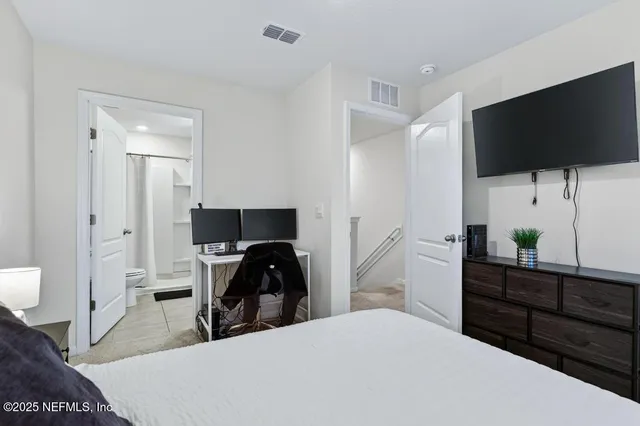 a bedroom with a bed and a flat screen tv