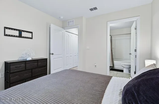 a bedroom with a bed and a dresser