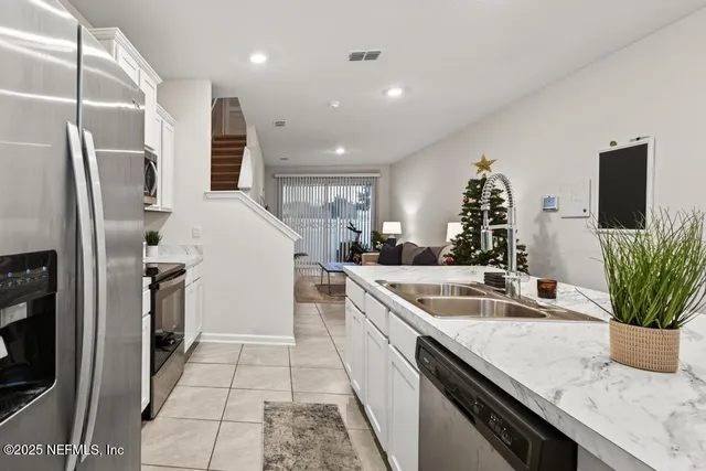 a kitchen with a sink and refrigerator