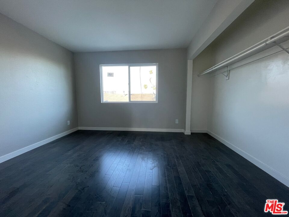7327 Willoughby Avenue, Unit 6 Los Angeles, CA 90046 - Photo 11 of 24 an empty room with wooden floor and windows