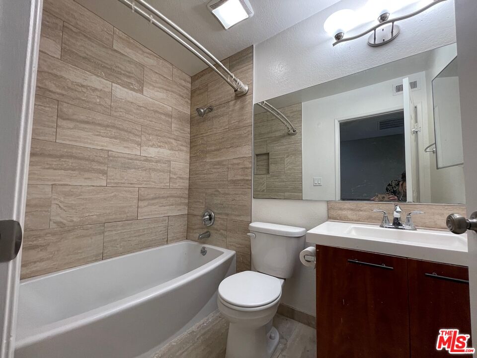 7327 Willoughby Avenue, Unit 6 Los Angeles, CA 90046 - Photo 12 of 24 a bathroom with a sink toilet and shower