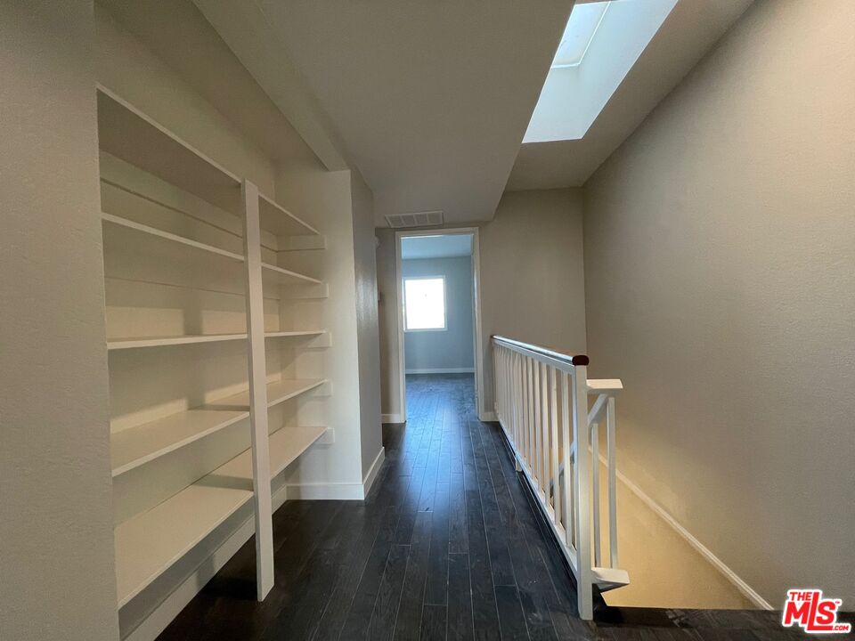 7327 Willoughby Avenue, Unit 6 Los Angeles, CA 90046 - Photo 13 of 24 a view of a hallway with wooden floor and closet