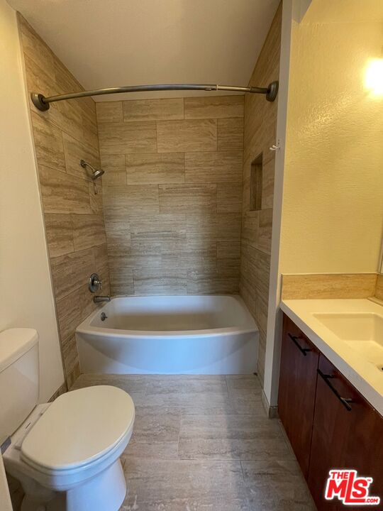 7327 Willoughby Avenue, Unit 6 Los Angeles, CA 90046 - Photo 19 of 24 a bathroom with a granite countertop bathtub shower sink mirror and toilet