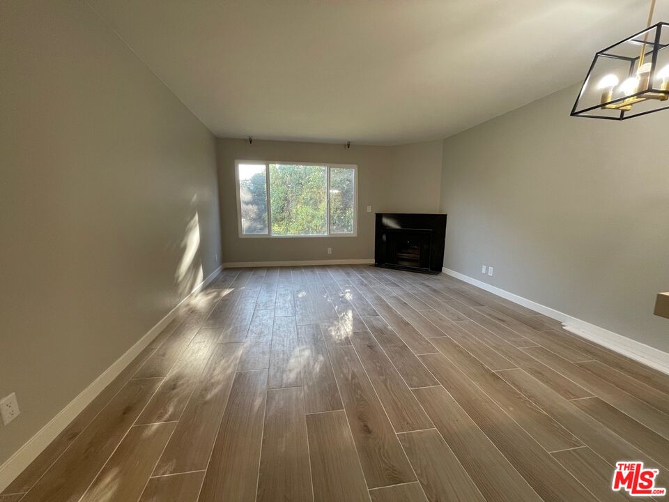 7327 Willoughby Avenue, Unit 6 Los Angeles, CA 90046 - Photo 2 of 24 wooden floor in an empty room with a window