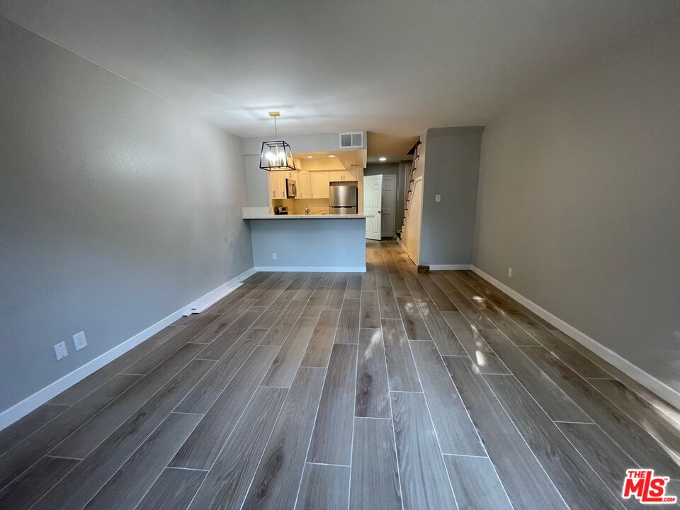 7327 Willoughby Avenue, Unit 6 Los Angeles, CA 90046 - Photo 3 of 24 a view of empty room with wooden floor