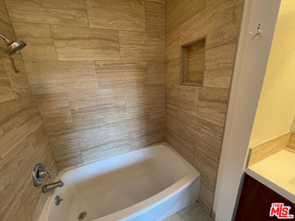 7327 Willoughby Avenue, Unit 6 Los Angeles, CA 90046 - Photo 7 of 24 a bathroom with a tub and shower