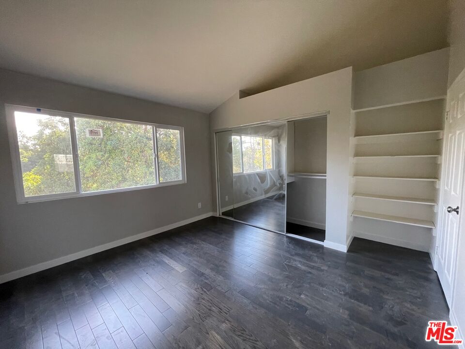 7327 Willoughby Avenue, Unit 6 Los Angeles, CA 90046 - Photo 8 of 24 wooden floor in an empty room with a window