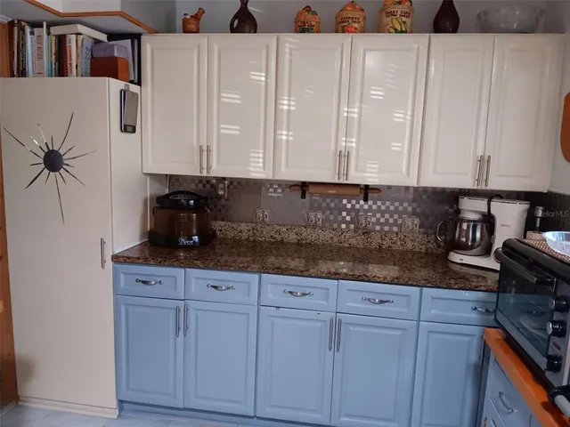 a kitchen with stainless steel appliances granite countertop a sink a stove and cabinets