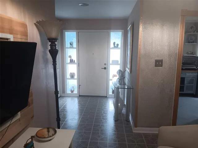 a view of hallway with furniture and wooden floor