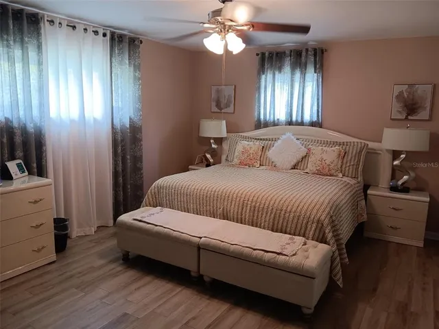a bedroom with a large bed and a chandelier