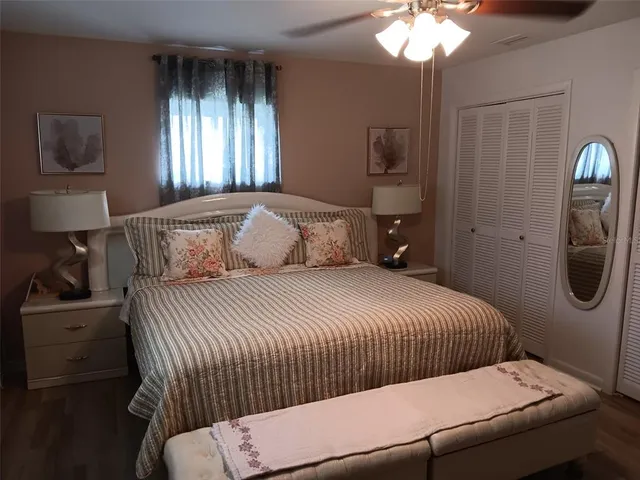 a bedroom with a bed and a chandelier