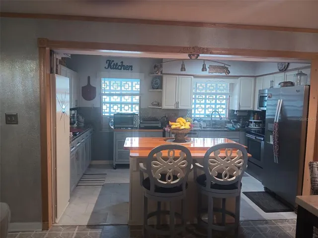 a view of a dining room with furniture and a large window