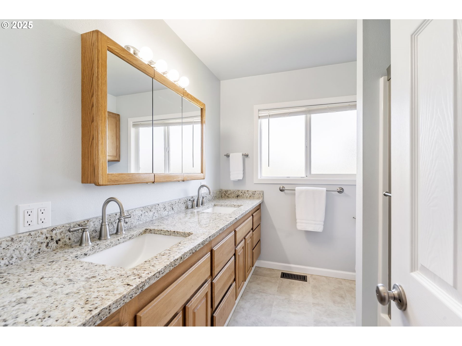 19117 Northeast 29th Avenue Ridgefield, WA 98642 - Photo 21 of 48 a bathroom with a double vanity sink and mirror