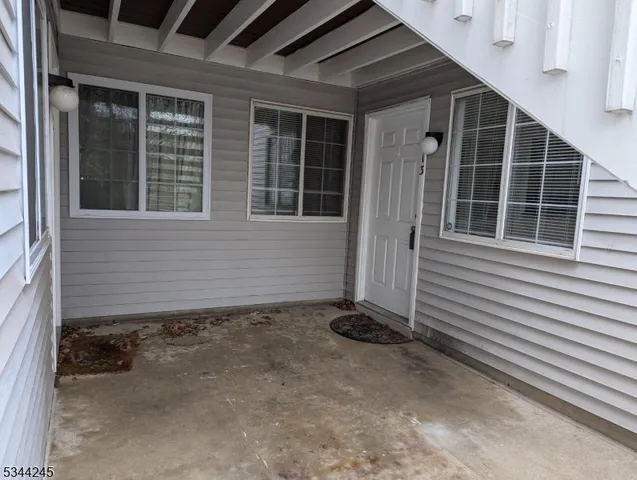 a view of a house with backyard and porch