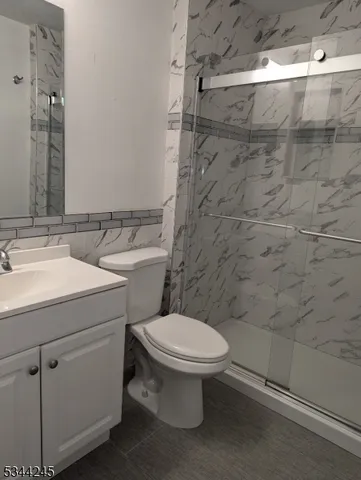 a bathroom with a toilet sink and shower