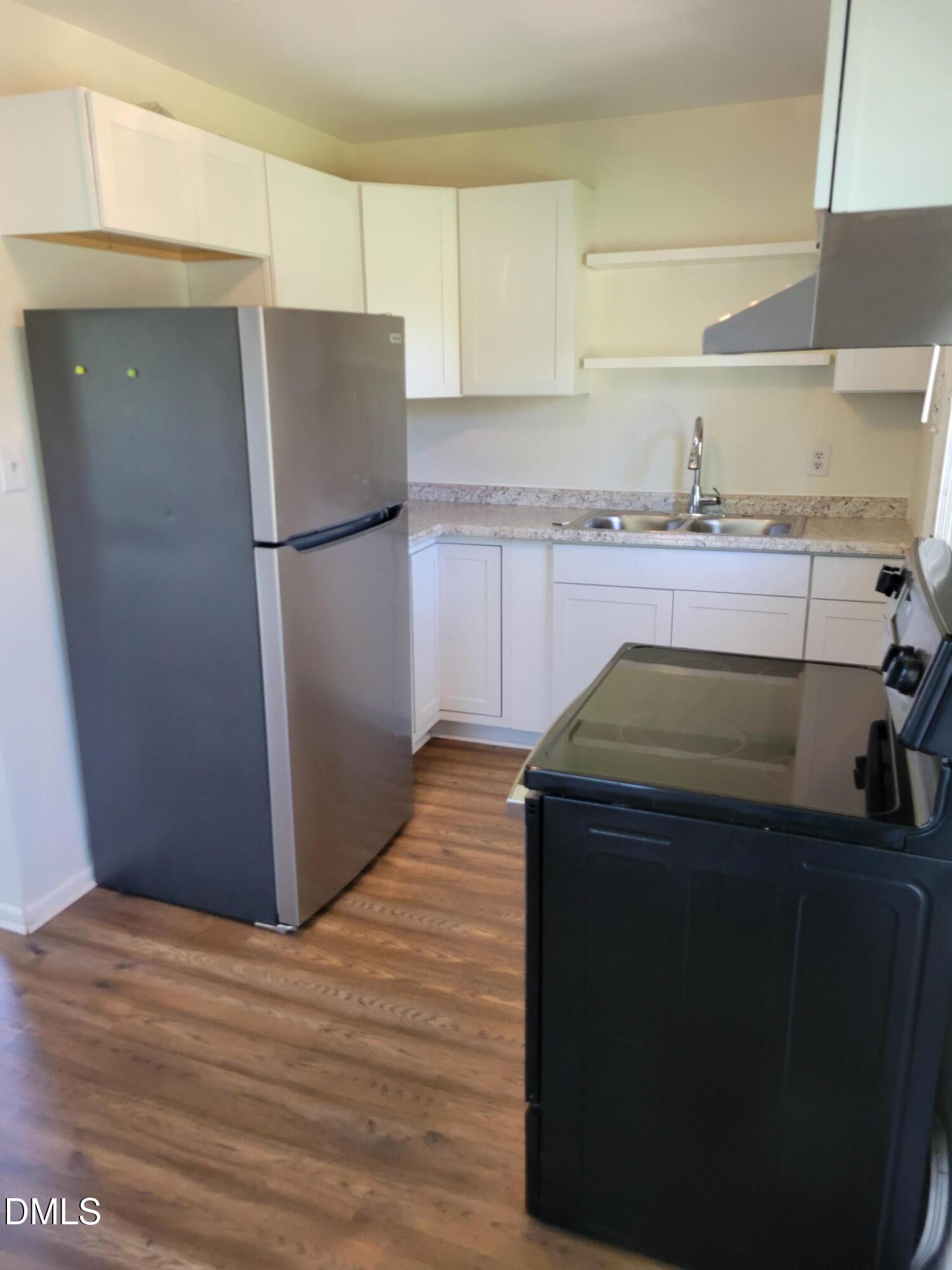 1145 Brighton Road Raleigh, NC 27610 - Photo 6 of 10 a kitchen with a refrigerator and cabinets