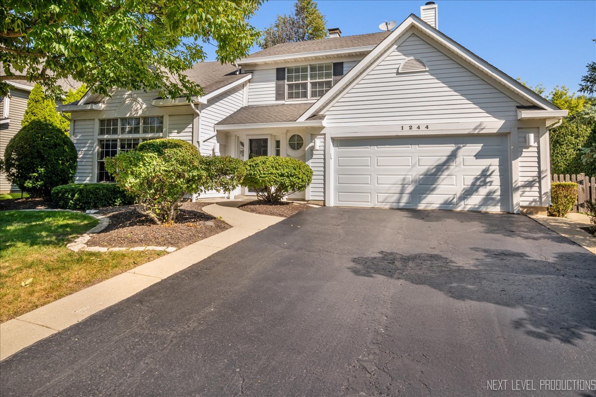 1244 Churchill Road Bartlett, IL 60103 - Photo 1 of 33 front view of a house and a yard