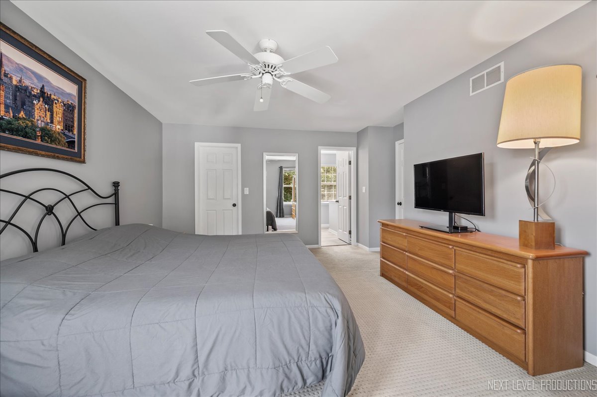 1244 Churchill Road Bartlett, IL 60103 - Photo 16 of 33 a bedroom with a bed and a flat screen tv