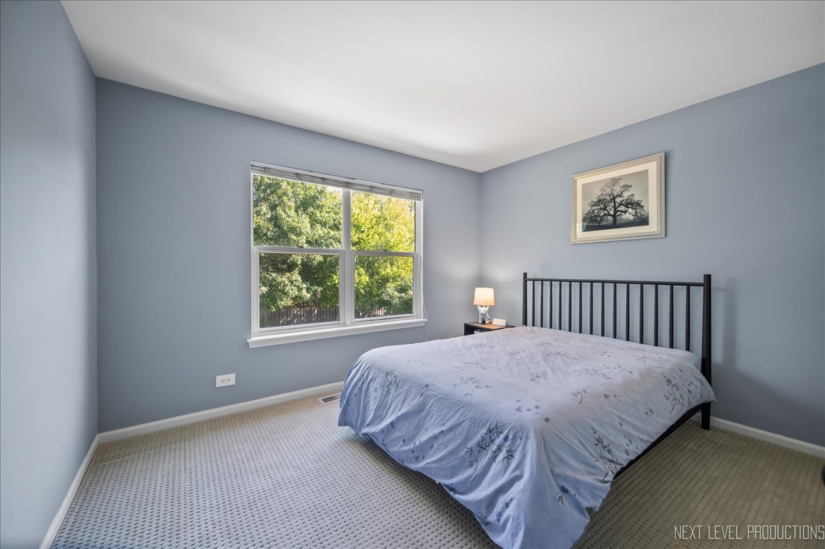 1244 Churchill Road Bartlett, IL 60103 - Photo 20 of 33 a bedroom with a bed and a window