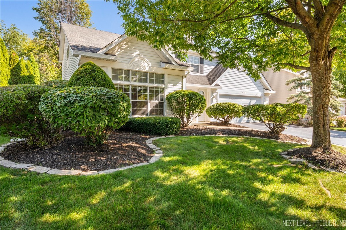 1244 Churchill Road Bartlett, IL 60103 - Photo 2 of 33 a front view of a house with garden