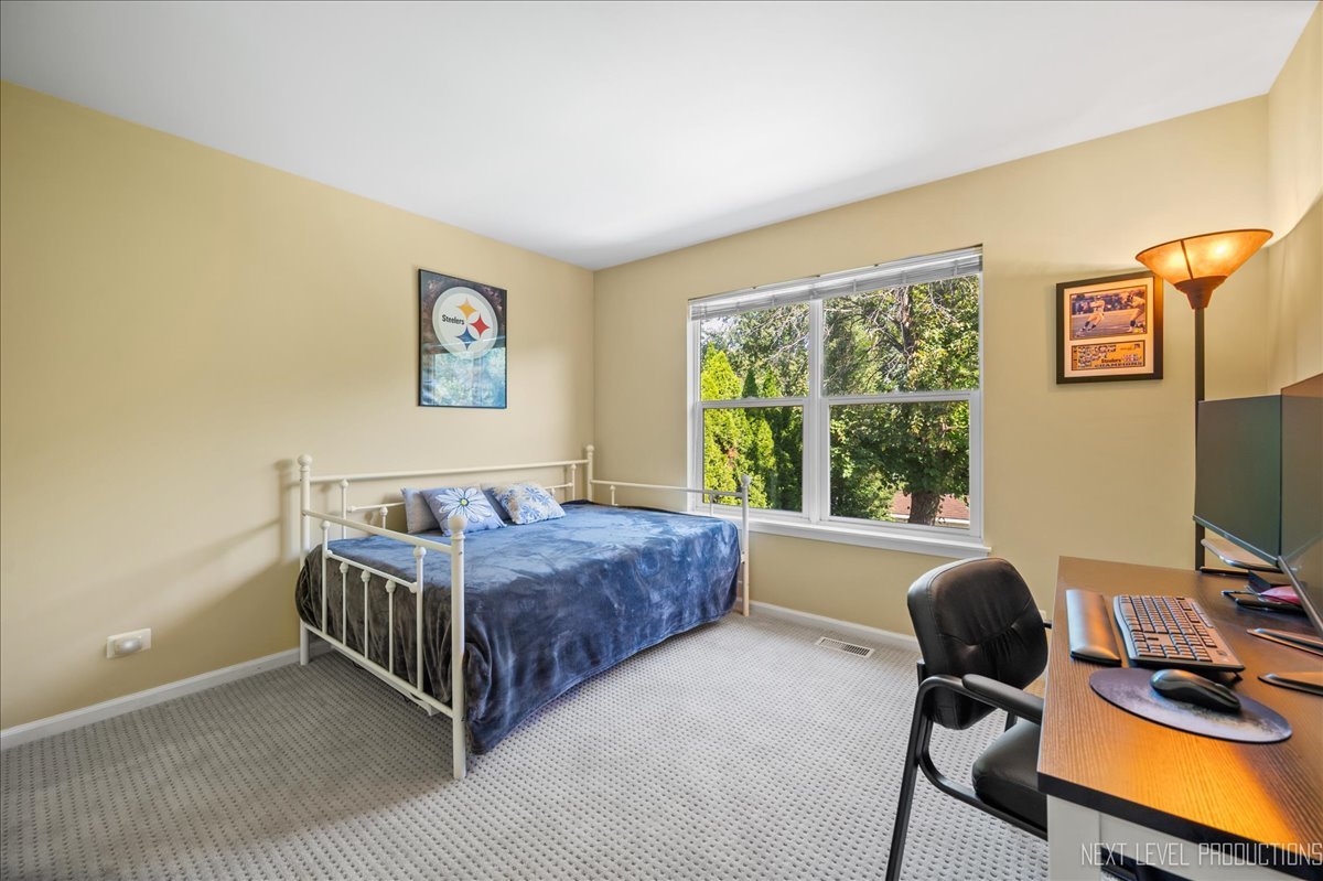 1244 Churchill Road Bartlett, IL 60103 - Photo 22 of 33 a living room with a bed furniture and a flat screen tv
