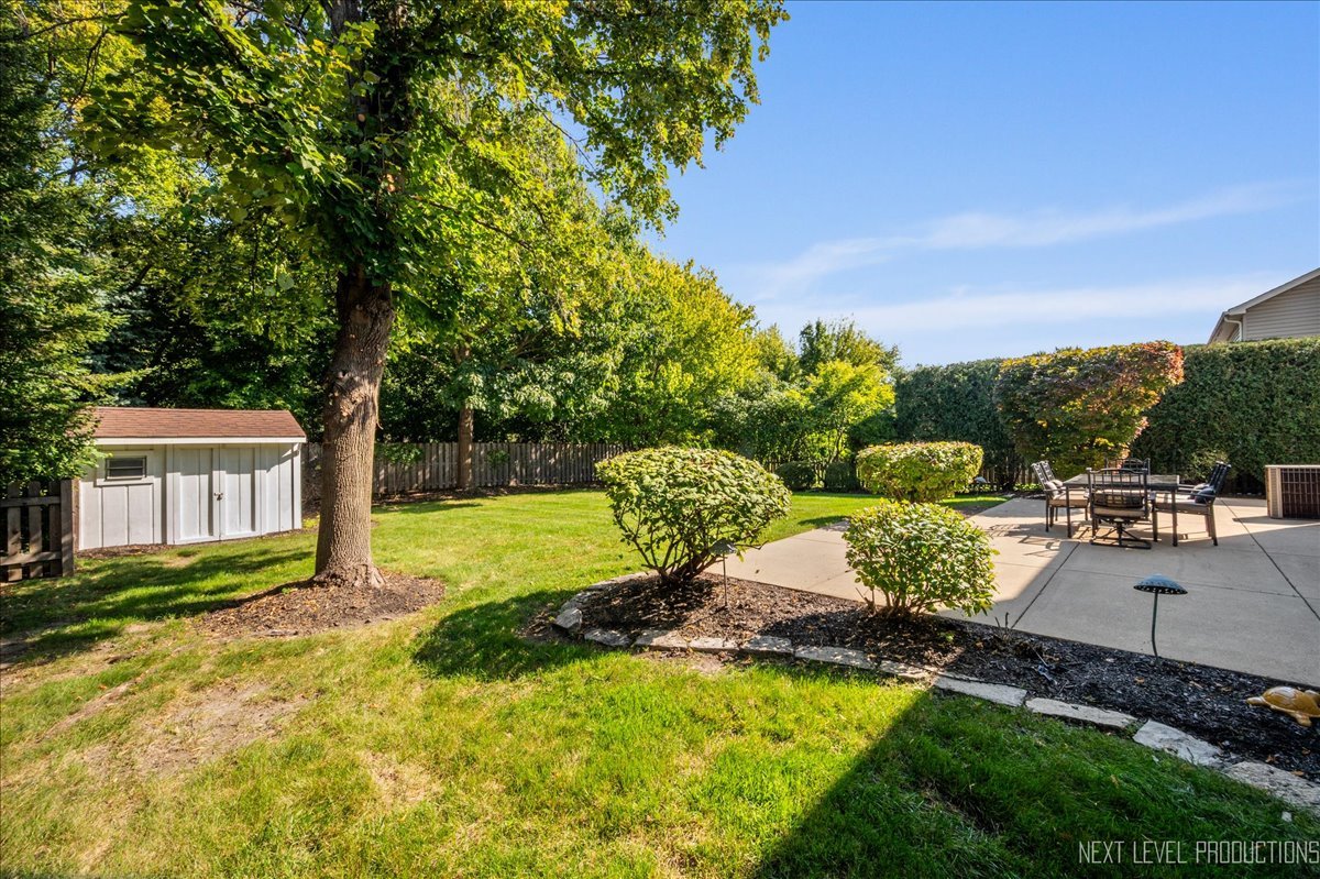 1244 Churchill Road Bartlett, IL 60103 - Photo 30 of 33 a view of a backyard with plants and patio