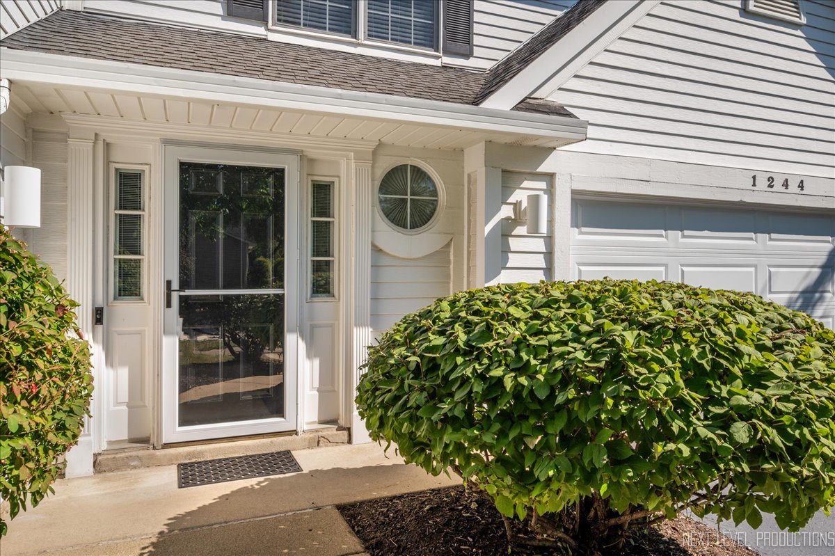 1244 Churchill Road Bartlett, IL 60103 - Photo 3 of 33 a front view of a house with garden