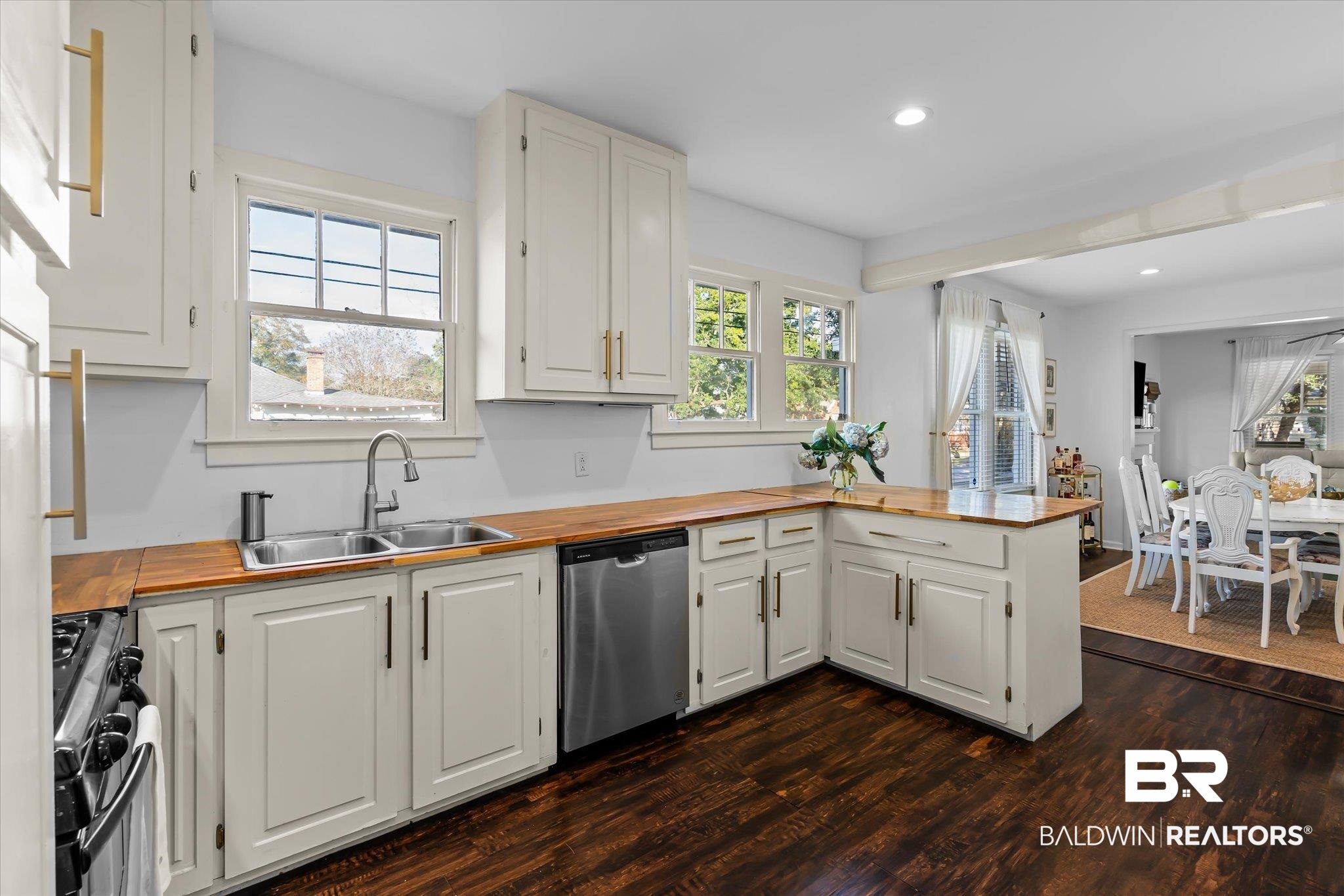 180 Williams Street Mobile, AL 36606 - Photo 9 of 20 Kitchen with white cabinets, kitchen peninsula, sink, and appliances with stainless steel finishes