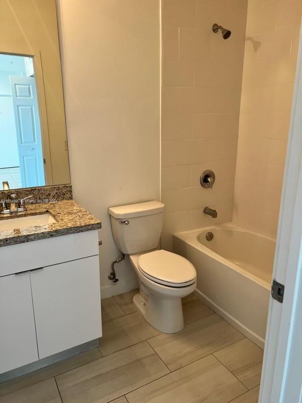 630 West 18th Street, Unit 109 Hialeah, FL 33010 - Photo 5 of 8 a bathroom with a granite countertop toilet a sink and a bathtub