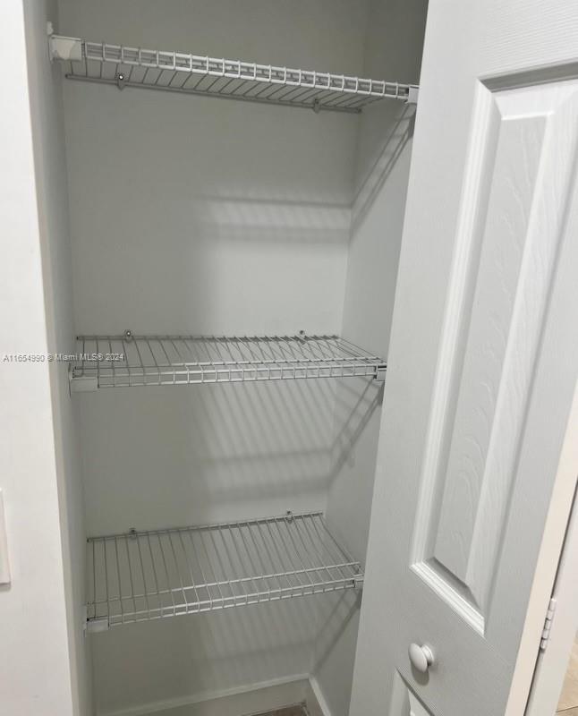 630 West 18th Street, Unit 109 Hialeah, FL 33010 - Photo 8 of 8 a view of walk in closet with empty racks