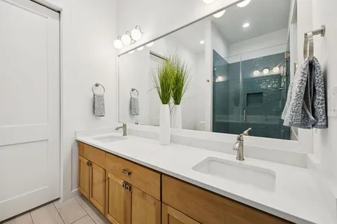 a bathroom with a double vanity sink and mirror